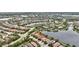 An aerial shot showcases the property's location within a community near the lake, lush surroundings, and various amenities at 12711 Del Corso Loop, Bradenton, FL 34211
