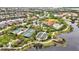 Community aerial showcasing tennis and bocce ball courts, a playground, and a pool area amidst lush landscaping and lakes at 12711 Del Corso Loop, Bradenton, FL 34211