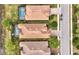 Birds eye view of homes with pools featuring terracotta tile roofs and tropical landscaping creating a private backyard oasis at 12711 Del Corso Loop, Bradenton, FL 34211