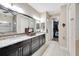 Bathroom with dual sinks, granite counters, and a shower at 12711 Del Corso Loop, Bradenton, FL 34211