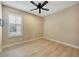 An inviting bedroom with wood floors, a ceiling fan, and natural light at 12711 Del Corso Loop, Bradenton, FL 34211