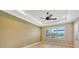 Bedroom with crown molding, ceiling fan, and window overlooking the backyard at 12711 Del Corso Loop, Bradenton, FL 34211