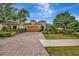 Charming home with lush landscaping, brick driveway, and two-car garage at 12711 Del Corso Loop, Bradenton, FL 34211