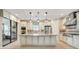 Bright kitchen featuring stainless appliances, white cabinetry, granite counters and a large island with pendant lighting at 12711 Del Corso Loop, Bradenton, FL 34211