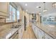 Spacious kitchen with granite counters, stainless appliances and a large island with seating at 12711 Del Corso Loop, Bradenton, FL 34211