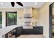 Outdoor kitchen features a built-in grill, sink, and bar, perfect for entertaining guests and Gathering cookouts at 12711 Del Corso Loop, Bradenton, FL 34211