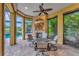 Enclosed patio featuring a fireplace, TV, and poolside views, creating an outdoor living space for relaxation at 12711 Del Corso Loop, Bradenton, FL 34211