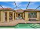 A covered patio features a swimming pool, a dining area and an outdoor kitchen, perfect for relaxation and entertaining at 12711 Del Corso Loop, Bradenton, FL 34211
