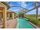 Screened-in pool with brick paver deck and serene water views, perfect for relaxation at 12711 Del Corso Loop, Bradenton, FL 34211