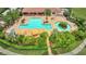 Aerial view of a sparkling pool surrounded by lush landscaping and lounge chairs at 12711 Del Corso Loop, Bradenton, FL 34211