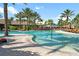 Exterior shot of a large swimming pool with lounge chairs and umbrellas in a tropical setting at 12711 Del Corso Loop, Bradenton, FL 34211