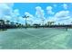 Full tennis court with lights and benches provides an active outdoor recreational amenity at 12711 Del Corso Loop, Bradenton, FL 34211