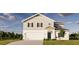 Two-story home with gray siding, black shutters, attached garage, and manicured lawn at 13040 Cedar Elm Lane, Parrish, FL 34219