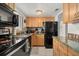 Efficient kitchen featuring modern appliances, ample counter space, and maple cabinetry at 1536 Leisure Dr # N4, Bradenton, FL 34207