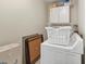 Functional laundry room equipped with a washer, dryer, and overhead storage cabinets at 1536 Leisure Dr # N4, Bradenton, FL 34207