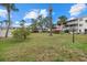 Expansive grassy common area featuring palm trees and colorful landscaping at 1536 Leisure Dr # N4, Bradenton, FL 34207