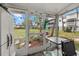 Relaxing sunroom with a view of the garden and lush greenery, ideal for unwinding at 1536 Leisure Dr # N4, Bradenton, FL 34207