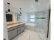 Elegant bathroom with dual sinks, soaking tub, and separate glass-enclosed shower at 1541 Music Ln, North Port, FL 34286