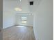 Bright bedroom with wood-look tile flooring, a neutral color palette, and recessed lighting at 1541 Music Ln, North Port, FL 34286