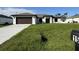 Beautiful single-story home featuring a well-maintained lawn and attached garage at 1541 Music Ln, North Port, FL 34286