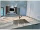 Modern kitchen sink with countertop, open to the living room and TV at 1541 Music Ln, North Port, FL 34286