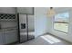 Modern kitchen featuring stainless refrigerator, gray cabinets, granite countertops, and stainless appliances at 1541 Music Ln, North Port, FL 34286