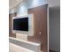 Stylish living room with a decorative wood panel and backlit TV feature wall at 1541 Music Ln, North Port, FL 34286