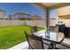 Backyard patio with outdoor dining set, a lush lawn and a privacy fence at 1570 Ludington Ave, Wesley Chapel, FL 33543