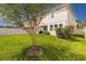 Spacious backyard offers a large green lawn and a covered patio, perfect for outdoor enjoyment at 1570 Ludington Ave, Wesley Chapel, FL 33543