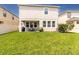 Well-maintained backyard featuring lush green grass, a covered patio, and a pristine vinyl fence at 1570 Ludington Ave, Wesley Chapel, FL 33543