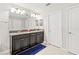 Bright bathroom featuring double sinks with granite countertops, and ample storage at 1570 Ludington Ave, Wesley Chapel, FL 33543