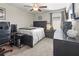 Bedroom with neutral walls, ceiling fan, and dark wood furniture at 1570 Ludington Ave, Wesley Chapel, FL 33543