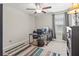 Bedroom or home office with ceiling fan, neutral walls, and a large desk at 1570 Ludington Ave, Wesley Chapel, FL 33543