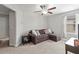 Cozy bonus room with a comfortable sofa, ceiling fan, and ample natural light at 1570 Ludington Ave, Wesley Chapel, FL 33543