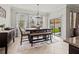 Bright dining area featuring a sliding glass door and modern farmhouse chandelier at 1570 Ludington Ave, Wesley Chapel, FL 33543