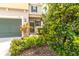 Beautiful landscaping surrounds the entryway of this lovely two-story home with a convenient attached garage at 1570 Ludington Ave, Wesley Chapel, FL 33543