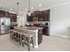 Spacious kitchen featuring a large center island with bar stool seating and dark cabinetry at 1570 Ludington Ave, Wesley Chapel, FL 33543