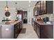 Well-lit kitchen with granite counters, stainless appliances, tile floor, and a large center island at 1570 Ludington Ave, Wesley Chapel, FL 33543