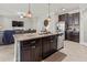 Kitchen featuring a large center island, stainless steel appliances, and an open view into the living room at 1570 Ludington Ave, Wesley Chapel, FL 33543