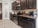 This kitchen offers granite counters, stainless appliances, mosaic backsplash, and dark wood cabinets at 1570 Ludington Ave, Wesley Chapel, FL 33543