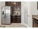 Modern kitchen featuring stainless steel appliances and dark wood cabinetry at 1570 Ludington Ave, Wesley Chapel, FL 33543