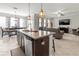 Open kitchen with a center island offering stainless steel appliances and a view of the living and dining areas at 1570 Ludington Ave, Wesley Chapel, FL 33543