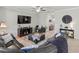 Inviting living room with stylish decor, dark wood accents, a ceiling fan, and an open layout at 1570 Ludington Ave, Wesley Chapel, FL 33543