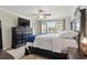 Comfortable main bedroom featuring a ceiling fan and large windows that provide ample natural light at 1570 Ludington Ave, Wesley Chapel, FL 33543