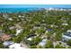 Expansive aerial view showcasing the property's location amidst lush trees near downtown and bay waters at 1764 Floyd St, Sarasota, FL 34239