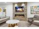 Cozy living room features a stone fireplace, modern furnishings, and serene, neutral tones at 1764 Floyd St, Sarasota, FL 34239