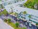 This aerial view shows the ample parking, well-maintained landscaping, and building facade in a desirable community at 1838 Sunny Dr # D35, Bradenton, FL 34207
