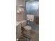 Compact bathroom featuring a toilet, patterned bathmat, and shower with frosted glass door in a functional space at 1838 Sunny Dr # D35, Bradenton, FL 34207