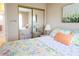 Cozy bedroom featuring floral bedding, closet with mirrored sliding doors, and decorative painting for a bright atmosphere at 1838 Sunny Dr # D35, Bradenton, FL 34207