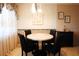 Cozy dining area with a round table, floral wallpaper, and decorative accents at 1838 Sunny Dr # D35, Bradenton, FL 34207